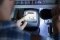 Person holding a torch points to the electricity meter reading