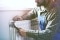 The picture shows an installer optimising the heating system at the radiator.