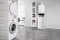 The picture shows a Vitodens 200-W wall mounted gas condensing boiler next to a Vitocell 100-W DHW cylinder in a modern utility room.