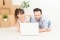 Happy heating owners in front of a laptop